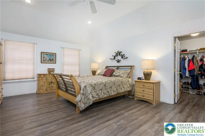 Primary bedroom is quite spacious with lovely tray ceiling w/fan, and a large walk-in closet. Newer vinyl plank flooring.