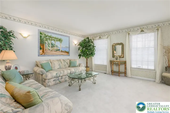 The formal living room is spacious and would allow for various furniture layouts.