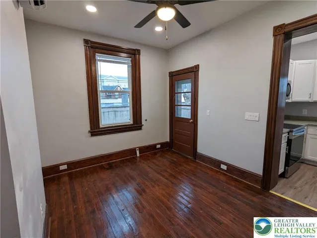 Living room toward balcony and kitchen.