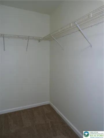 Primary bedroom walk in closet