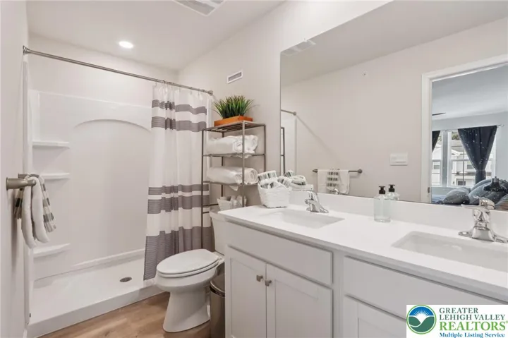 Primary bath with double vanity, large shower.