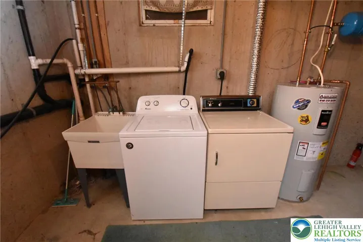 Basement Laundry Room with Washer, Dryer, Sink & Water Heater