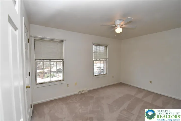 2nd Bedroom with ceiling-fan light overlooks the front