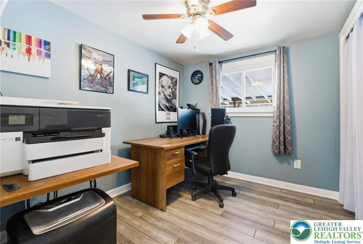 Bedroom with light / fan & hardwood floors