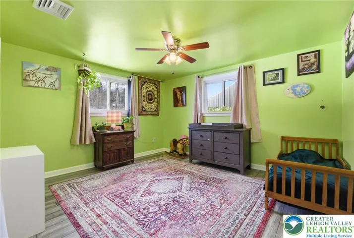 Bedroom with light / fan & hardwood floors
