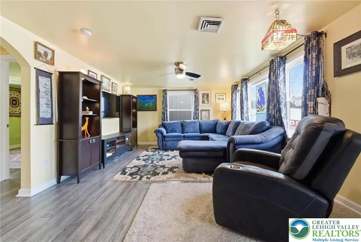 Light & Bright Family Room with Fan/Light and large windows & hardwood floors