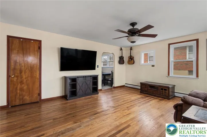 Decent sized living room with plenty of light and wood floors