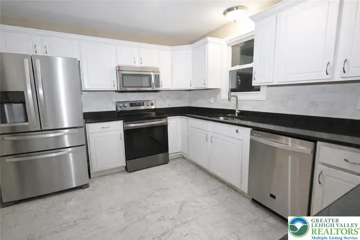 Kitchen with granite and stainless appliances