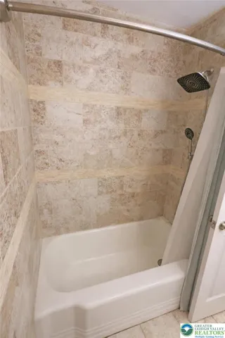 Full bathroom tub with decorative tile surround