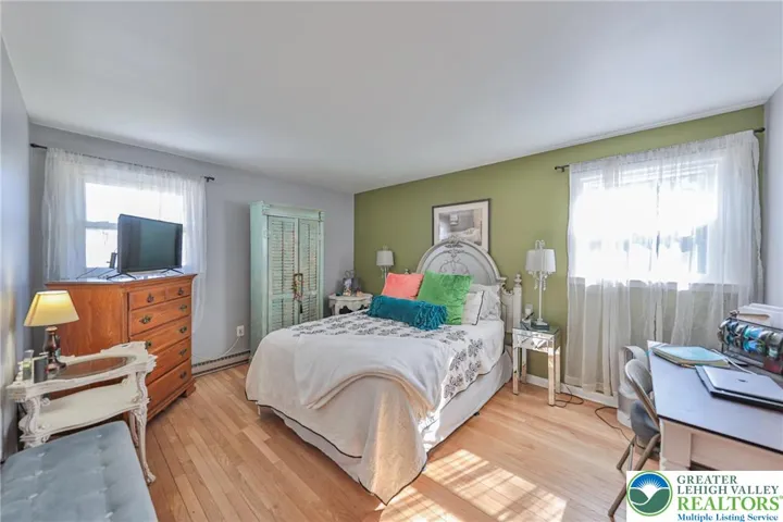Primary Bedroom with Hardwood Flooring
