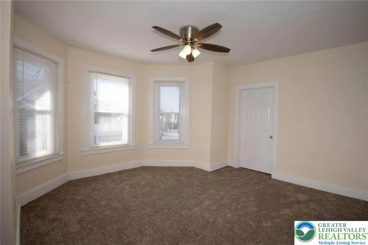 bedroom area with w/w carpeting and lots of windows and natural light