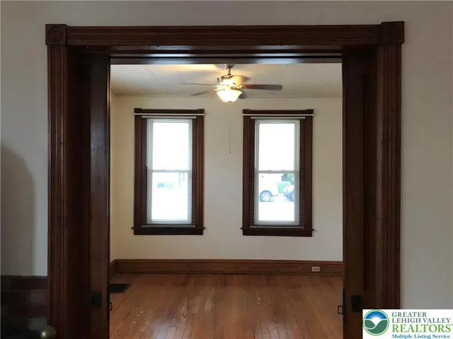 pretty wood trim with pocket doors adds character and charm