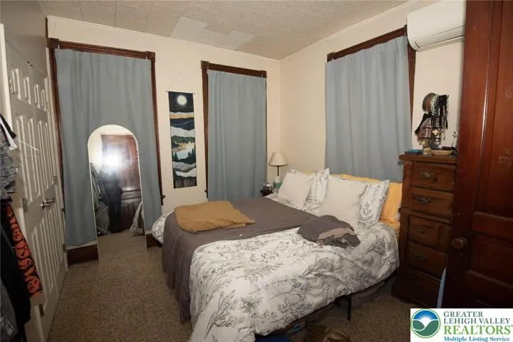 note the charming wooden window trim in 730 1st floor bedroom; mini split on wall