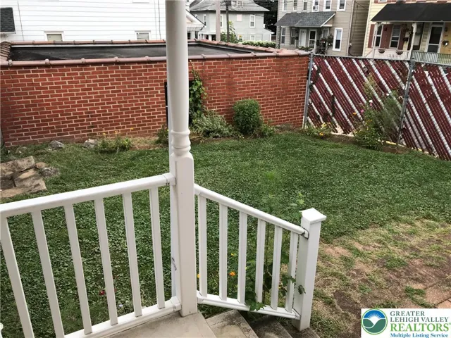 728 side of home and view of yard and side of garages; just enough space to have a small flower garden and to relax outdoors