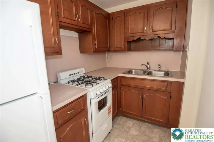 plenty of cabinetry, formica counter tops, and stainless steel appliances