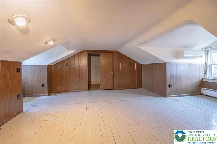 attic bedroom with walk in closet