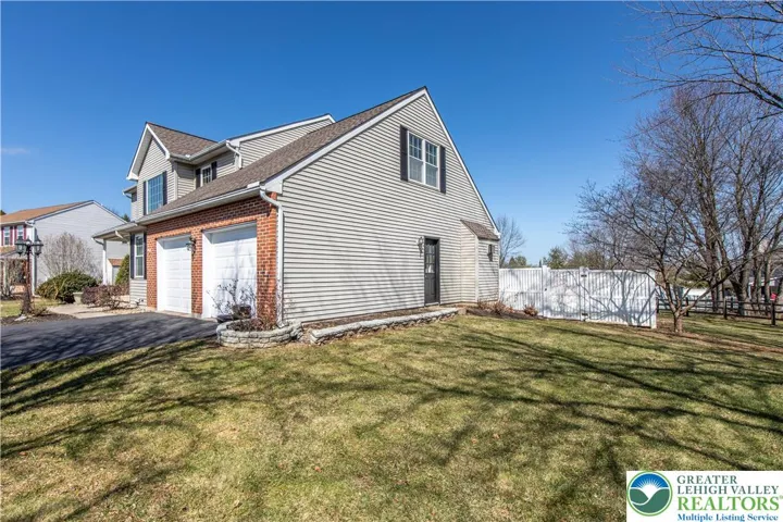 Side of home w side entry to garage