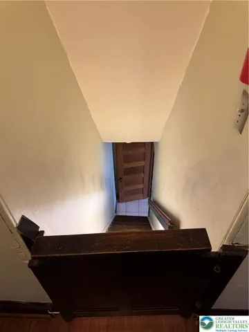 back staircase with wooden gate