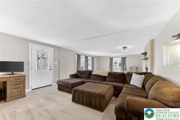 MASSIVE FINISHED BASEMENT WITH GORGEOUS STONE FIREPLACE AND WALKOUT