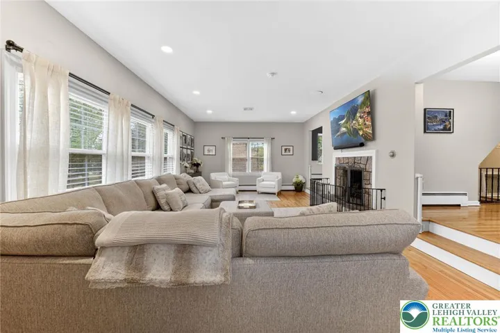 LIVING ROOM WITH STONE FIREPLACE