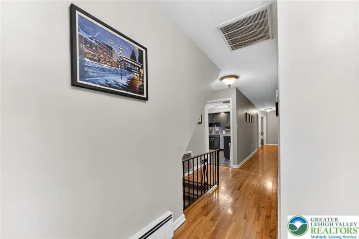 HALLWAY WITH HARDWOOD FLOORS!