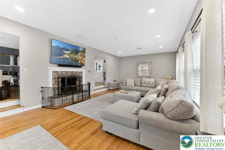 LIVING ROOM WITH STONE FIREPLACE