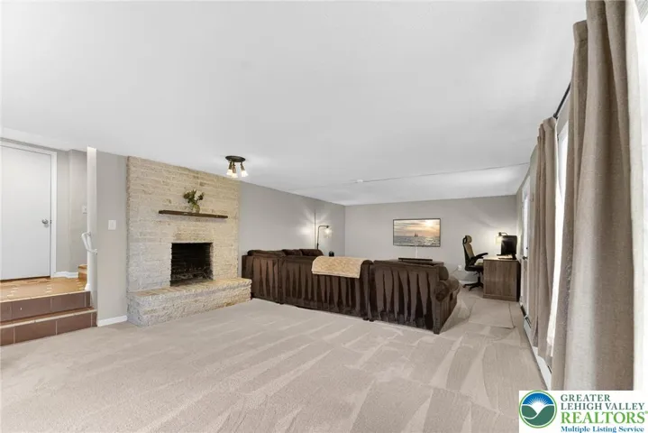 MASSIVE FINISHED BASEMENT WITH GORGEOUS STONE FIREPLACE AND WALKOUT