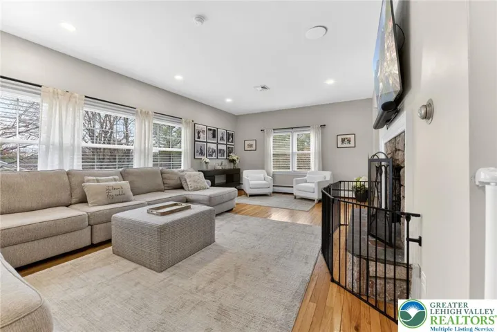 MASSIVE BRIGHT LIVING ROOM WITH STONE FIREPLACE