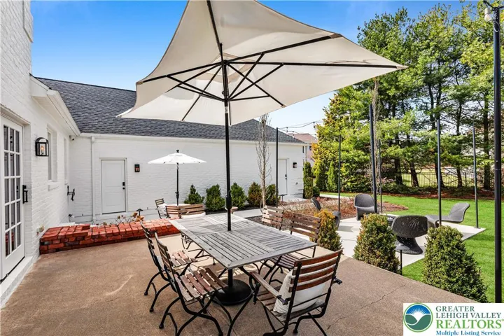 Elegant landscaped grounds featuring multi-tiered sitting and entertaining areas. New trees, bushes and plantings