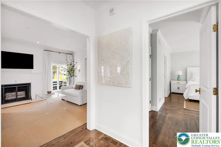 
Open sightline from the family room to the entry of the master ensuite—gracious flow, hardwood flooring, and abundant natural light connecting the primary living and private quarters.