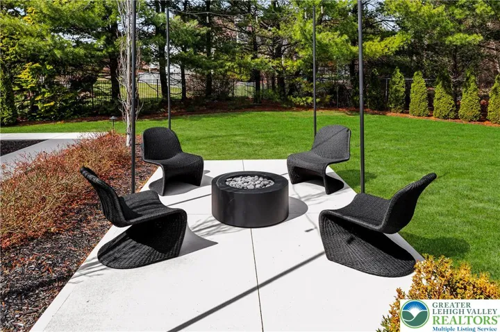 
Elegant landscaped grounds featuring custom wrought-iron fencing that frames the property with timeless curb appeal and security.
