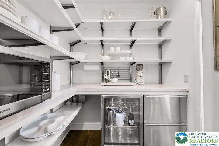 Pantry area with abundant storage, custom cabinetry, built-in shelving, and task countertops—efficiently organized for meal prep and household needs.