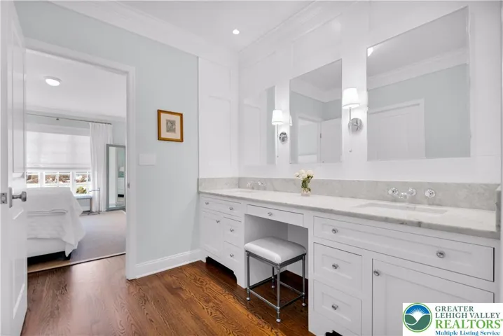 
Built-in, soft-close medicine cabinets recessed behind mirrors for concealed, organized storage and smooth, quiet operation. Double-sink marble vanity with integrated makeup area—seated vanity with task lighting, mirror, and dedicated storage for cosmetics and accessories.