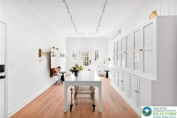 Multipurpose office/studio — built-ins, luxury plank flooring, and quiet mini-split comfort