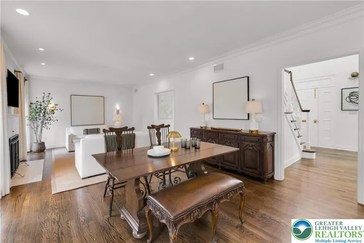 Cozy dining area between the kitchen and family room with hardwood flooring and a new Pella sliding door, creating a bright, seamless indoor-outdoor transition.