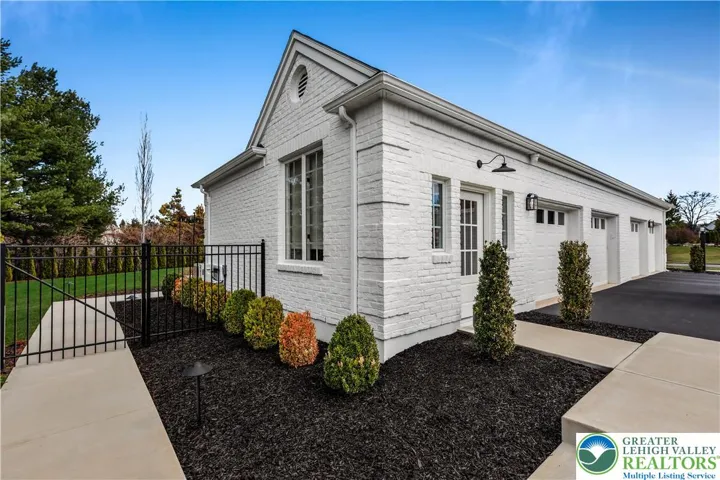 4 car garage - 1st two bays have epoxy coated floor and pull down access to the expansive attic space.
Entrance to office/studio on left end. Gated backyard. New sidewalks