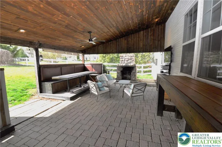 Covered Patio & Seating Area w/ Wood Fireplace
