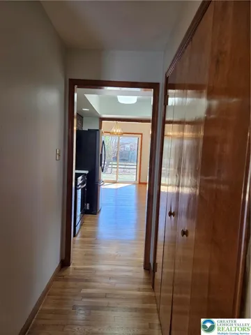 hall leading to the half bathroom, laundry room and galley kitchen