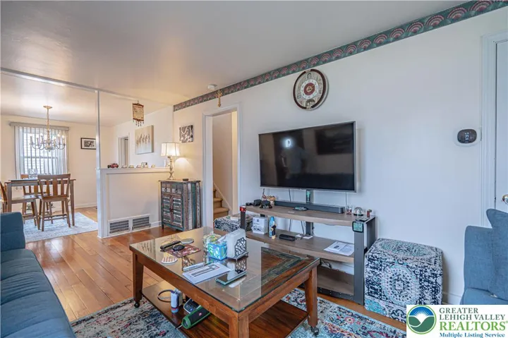 Living room flows seamlessly into dining rm