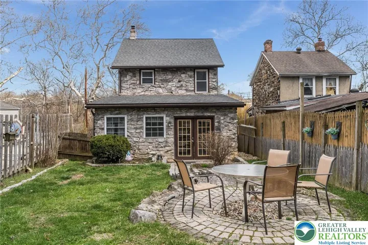 Fenced in yard with shed and access to rail trail