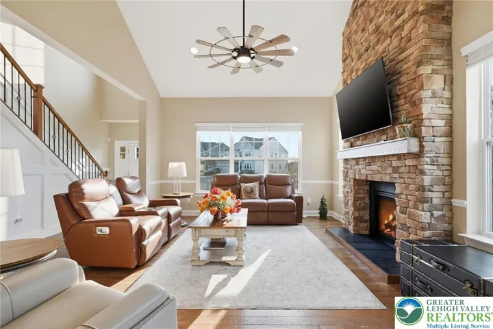 Spacious living room anchored by a stunning stone fireplace