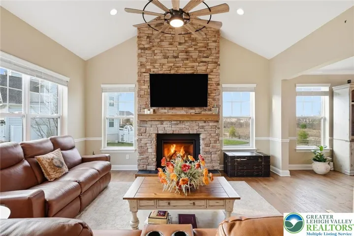 Spacious living room anchored by a stunning stone fireplace