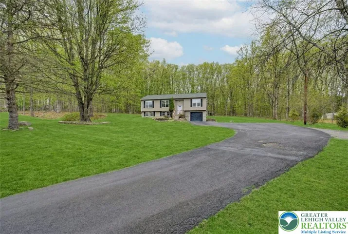 Long Paved Driveway To Home