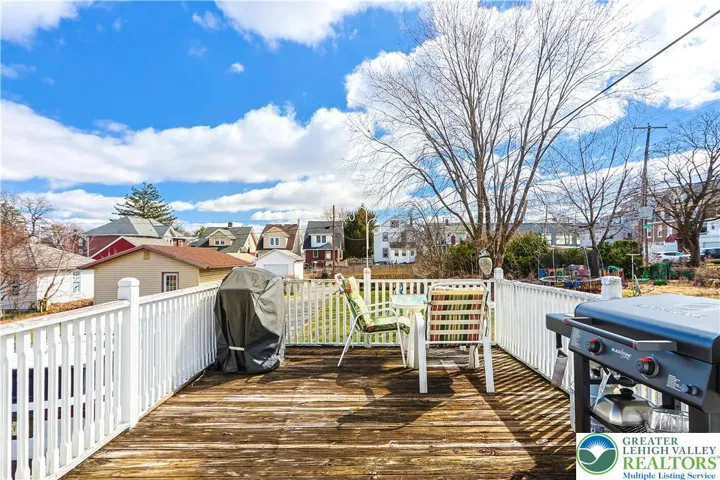Enclosed Porch Leads to Elevated Deck for Outdoor Entertaining