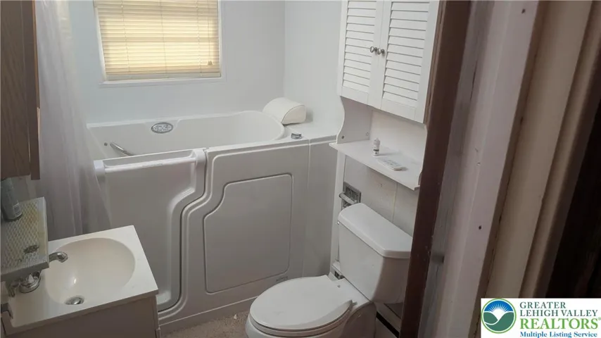 Full Bathroom with walk-in jetted tub.