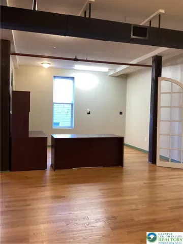 Off vestibule, across from secondary entrance.
