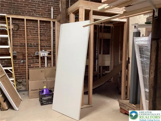 Partially-completed additional laundry and 1/2 bathroom area at rear of shop.