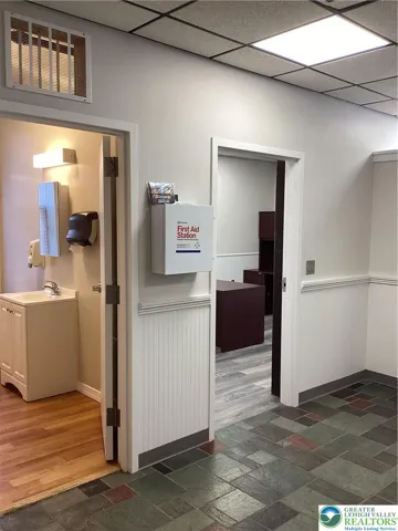 Off vestibule, 1/2 bath and private room.