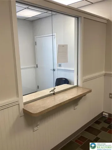 Through partition wall towards entrance.