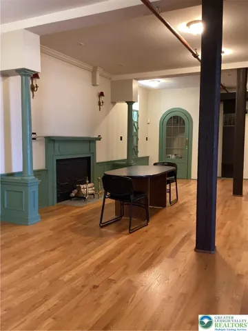 Rear space, across from additional bathrooms.